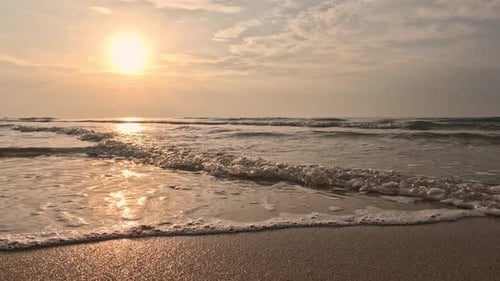 Wave splashing in sunrise or sunset on a tropical beach.