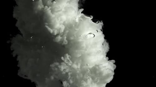 Swirling White Ink Dropping and Dissolving in Water