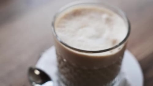 Latte In Glass On Cafe Table Close Up