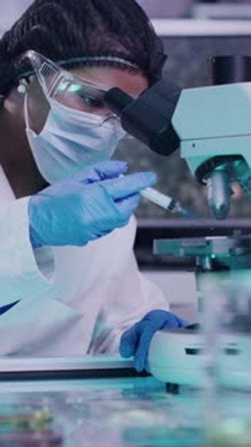 Scientist Woman Works with Microscope in Lab Setting