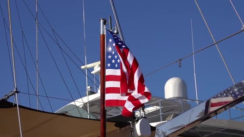 American Flag Waving on Luxury Yacht on Sunny Day