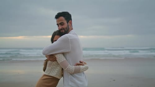 Carefree Newlyweds Cuddling on Evening Beach Closeup. Smiling Man Kissing Positive Woman