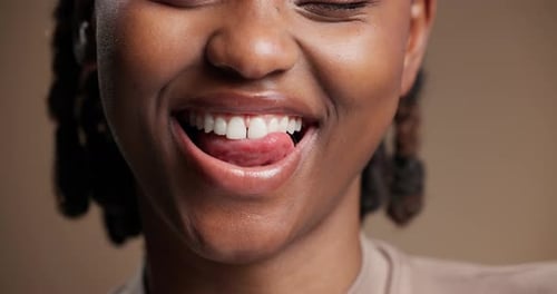 Dental, closeup or black woman in studio with lick, mouth or tooth wellness in orthodontics