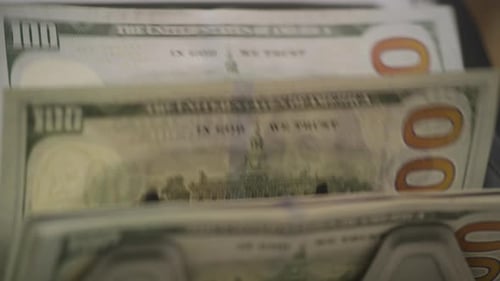 CloseUp of 100 Dollar Bills Moving Through Money Counter