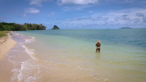 Ein Mädchen in gelbem Bikini und Strohhut auf einer paradiesischen Insel verkörpert den Nervenkitzel von Reisen, Tourismus,