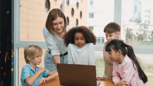 Cute girl programing system while surround with teacher and friend. Erudition.