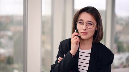Businesswoman Talking on Phone in Modern Office