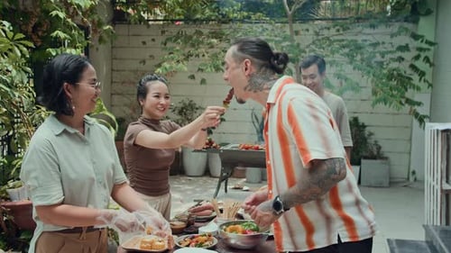 Adults Enjoying Barbeque in Urban Backyard
