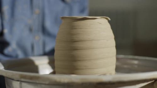 Potter Shaping Clay on Spinning Pottery Wheel