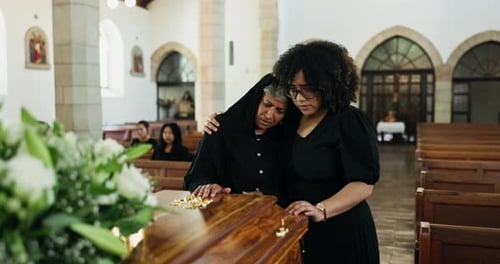 Grief, loss and women hug at coffin empathy at memorial service at church for respect
