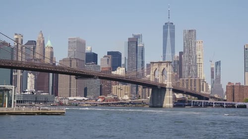 Manhattan's financial district with the One World Trade Center and the Brooklyn Bridge at a sunny da