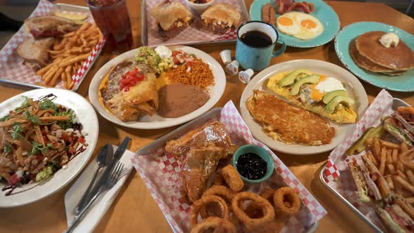 Tabletop assortment of restaurant plates, hearty homecooking style ...