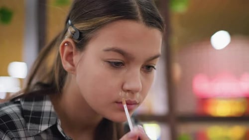 Teen Girl Applying Concealer Makeup with Brush