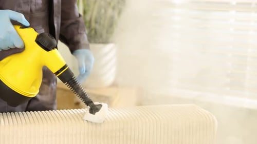 Radiator steam cleaning with bright yellow steamer