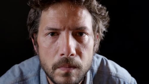 Man Puts on Glasses and Smiles