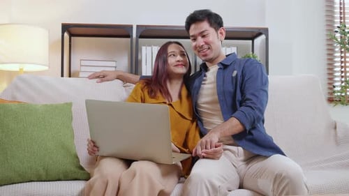 Couple Relaxing at Home with Laptop