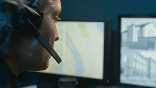 Closeup Dispatcher at Police Station Watching Screens with Cctv Feed