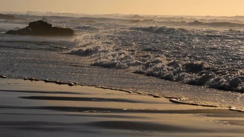 Sea Waves Hitting Beach in Sunny Morning. Close Up Rocky Coastline Washing