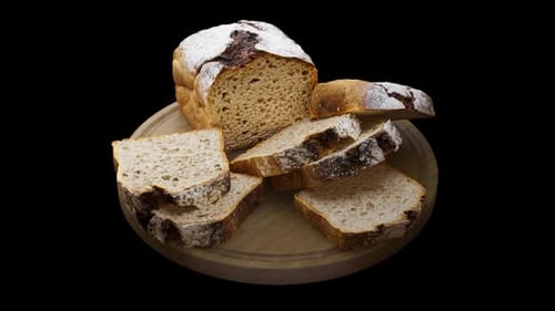 Isolated Rustic Bread Loaf and Slices Rotating on Wooden Board