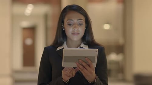 Professional Woman Uses Tablet Device Indoors