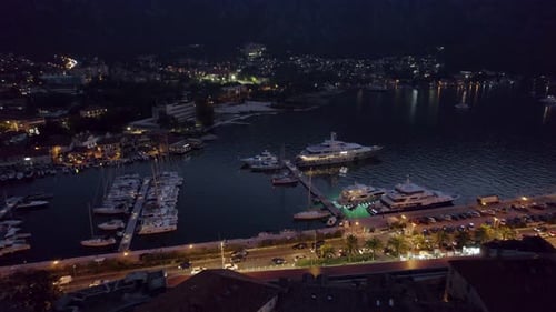 Aerial view at night of yachts and sailboats in the Port of Kotor in Montenegro