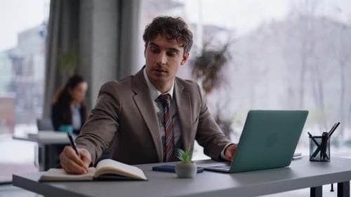 Company Worker Creating Project Noting Ideas in Copybook at Workplace Closeup