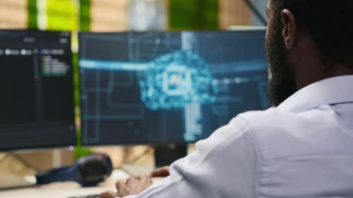 Technician in Wheelchair Using AI on Computer to Optimize Performance