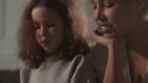 Girl Studies Music with Adult at Home