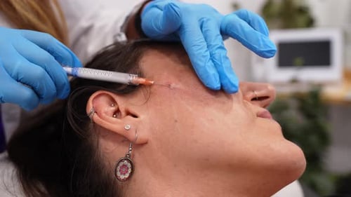 Woman Receiving Dermal Filler Injection in Cheekbone