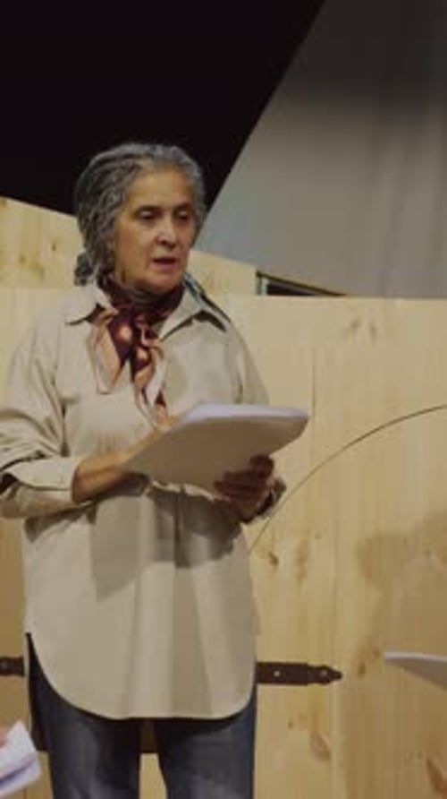 Mature Theatre Director Explaining Play Script to Actors on Rehearsal