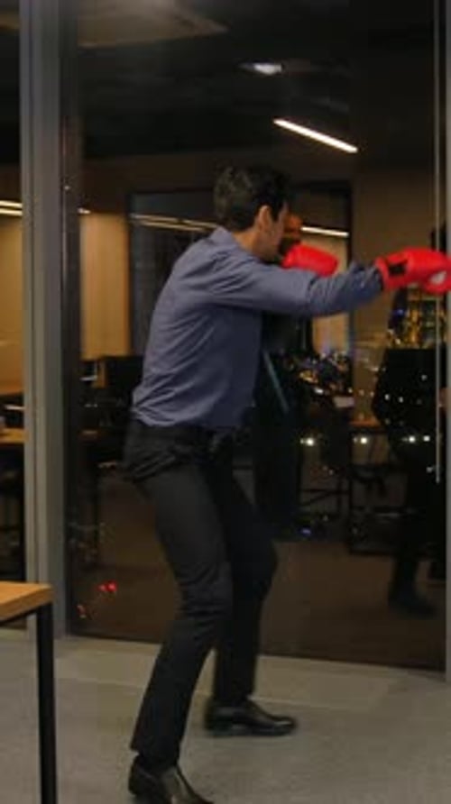 Young Adult Practices Boxing in an Office