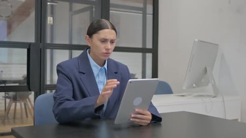 Woman Uses Tablet, Receives Bad News at Work