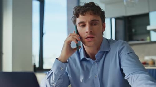 Angry Man Arguing on Phone at Desk
