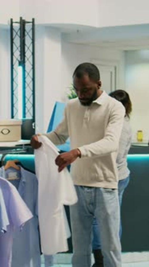 Man Browsing Fashion Shirts in Clothing Store