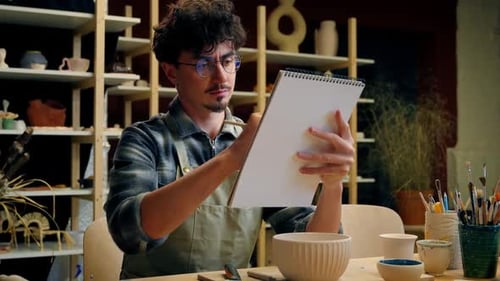 Artist Drawing Pottery Sketch in Creative Studio