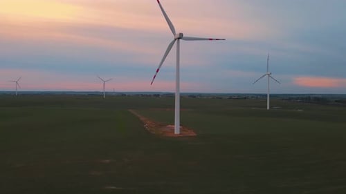 Scenic Aerial View of Windmill Turbines Farm in Sunset Time Generating Green Energy