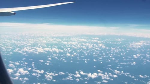 Aircraft Wing View From Airplane With Cloudy Sky Flying From Australia To Singapore - POV