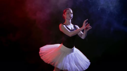 Graceful Ballerina Whirling in Darkness with Red and Blue Soffits Slow Motion Passion and Tender