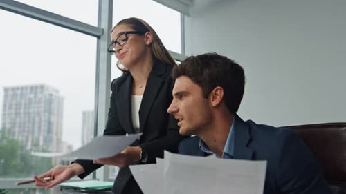 Business Colleagues Reviewing Documents in Modern Office