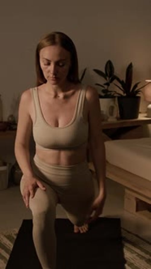 Woman Doing Low Lunge Yoga Pose Indoors