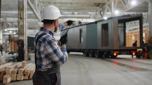 Construction Worker Directing Modular Home Loading Process