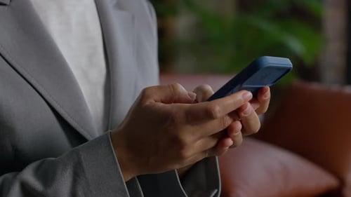 Hands Typing Message on Smartphone Close Up