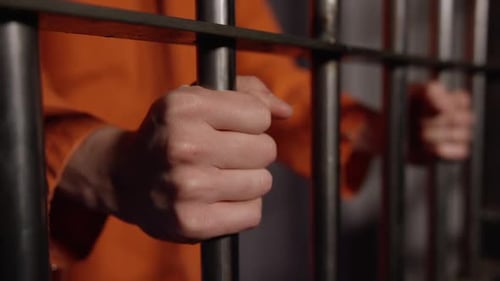 American Prison System White Hand In Jail on bars