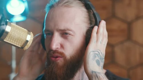 Singer Singing Into Microphone Wearing Headphones