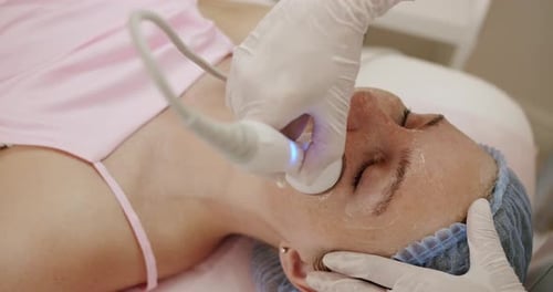 Adult Woman Receiving Facial Treatment at a Clinic