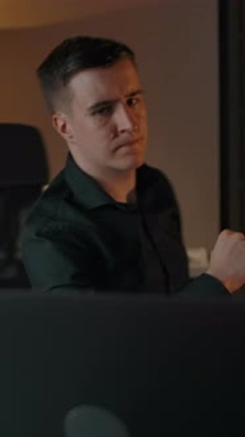 Man Works at Computer at Night Indoors