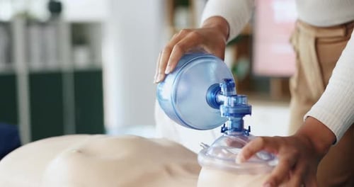 Hands Operate Bag Valve Mask on Mannequin