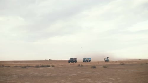 Filming trucks driving across the steppe. filming from a crane in the desert