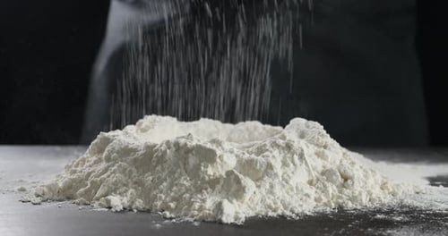 Powdered Flour Sifting Through Sieve onto Flour Mound