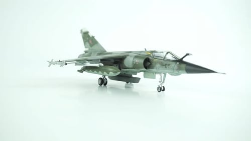 Model Fighter Jet Rotating on White Surface